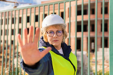 A woman Builder at a construction site inspects a buildingの写真素材