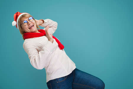 Christmas woman in shirt and jeans on blue background