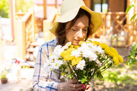 A woman is gardening in her backyard, she plants seedlings.の写真素材