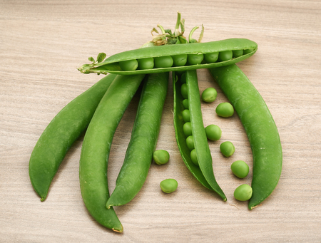 Delicious green peas on an wooden table