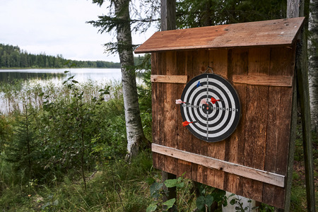 Playing darts outdoors by the lake in Finland.