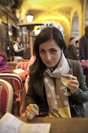 a girl drinking a glass of white wineのeditorial素材