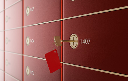 close up view of a stack of safe boxes, one of them with a key (3d render)の写真素材