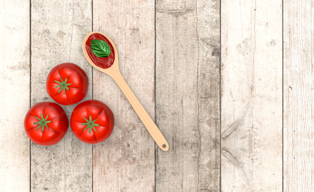 top view of red tomatoes and a wooden spoon and sauce, on wooden background, with empty space for custom text (3d render)の写真素材