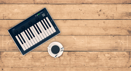 top view of a tablet pc with a piano app on wooden background, concept of music and technology, empty space at the right (3d render)の写真素材