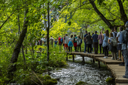 A row of people over a wooden walkwayのeditorial素材