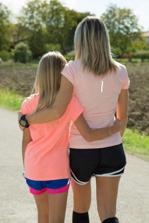 two blonde girls ready to runの写真素材