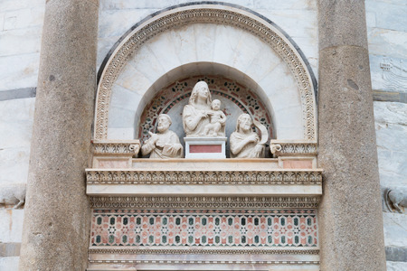 Pisa leaning tower arch and statues above the entrance doorの写真素材