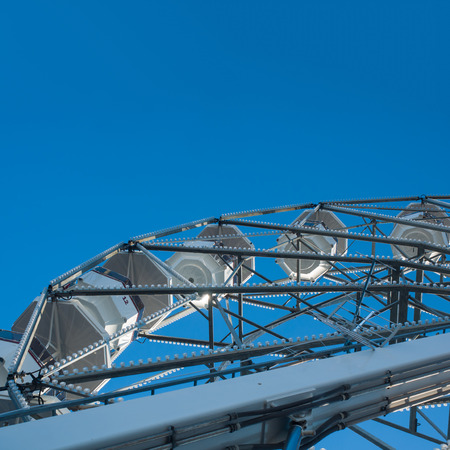 Ferris wheel detail of some cabins blue sky in the background. square formatの写真素材