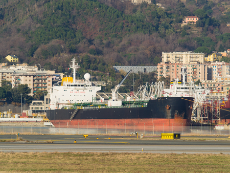Genoa Italy_December 23, 2017: big oil chemical tanker moored in a port next to the buildings of the city
のeditorial素材