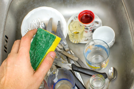 chores washing dishes sink sponge handの写真素材
