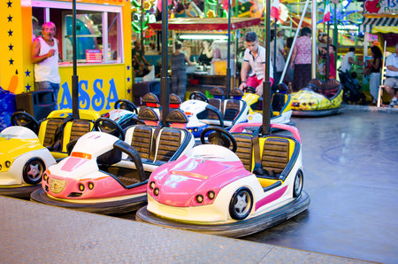 Ferrara, Italy, August 9 2015: pink bumper car for childrens parked in a luna park at nightのeditorial素材