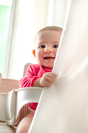 baby hide curtains playful newborn smileのeditorial素材