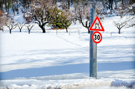 danger road sign snowの写真素材