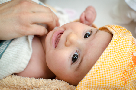 newborn eyes closeup gaze baby face portrait hoodの写真素材
