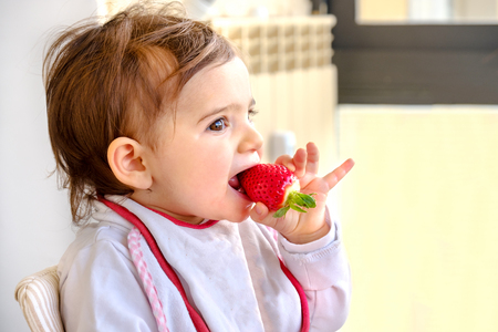 baby eat strawberry newborn eat fruitの写真素材