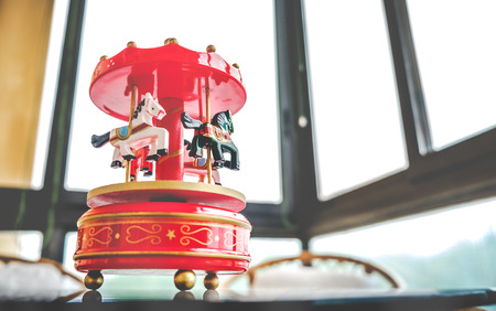 retro filtered toy music box red toned merry go round carousel horsesの写真素材