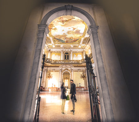Stra, Italy, 25 April 2017: a young couple chat inside a large and regal hall of Villa Pisaniのeditorial素材