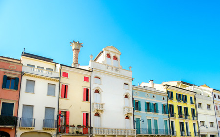 row of Italian residential buildings colorful blue skyの写真素材
