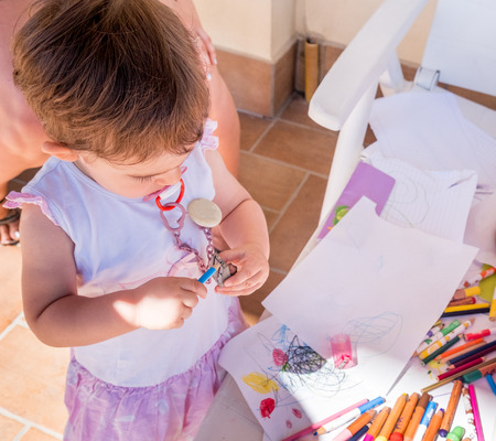 baby girl sharpening pencilの写真素材