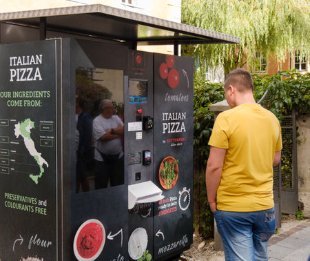 Brunico, Italy, 12 aug 2017- tourists try a pizza vending machine