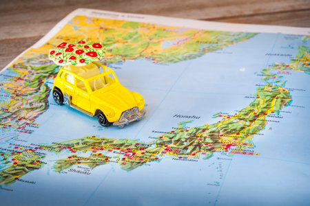Japan map paper yellow beetle toy car background