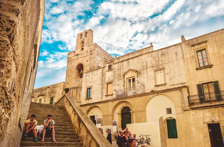 Otranto, Italy kids sit  stairs old town outside  Otranto basilのeditorial素材