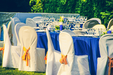 wedding chairs catering table background in gardenの写真素材