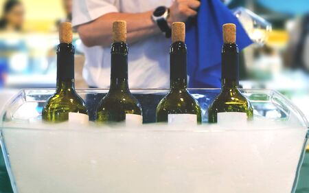 Catering bartender Italian fine wine bottles winetasting session sommelier waiter serving wine people clean glasses backgroundの写真素材
