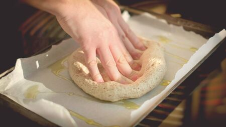 horizontal pizza dough background italian cookery hands on dough on bakin sheet olive oil homemade...