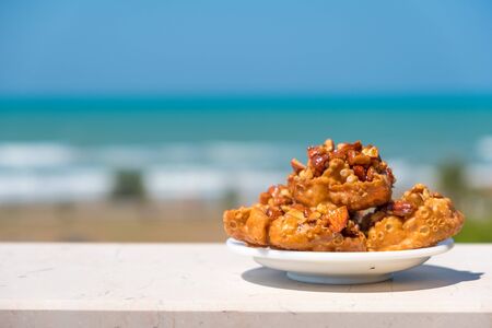 italian traditional food from Puglia region named Cartellate Pugliesi, crispy puff pastry with honey and almondの写真素材