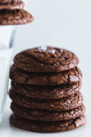Chocolate cookie with a glass of milk and a white backgroundの写真素材