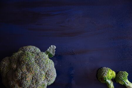 Broccoli on a blue wood surfaceの写真素材