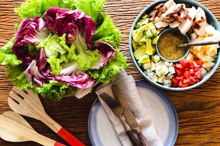 Homemade cobb salad on a rustic wood surface.の写真素材