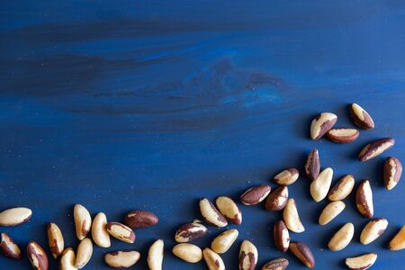 Brazilian nuts on a blue surface.の写真素材