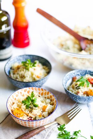 homemade couscous with cherry tomatoes and fresh herbs.の写真素材
