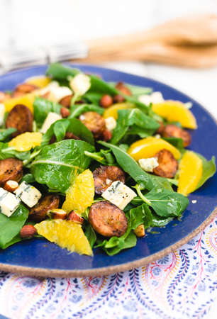 Arugula and roasted potato salad with orange, blue cheese and almonds.の写真素材