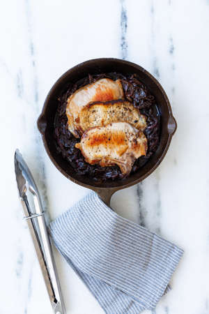 Raw chicken breat with olives, lime and garlic.の写真素材