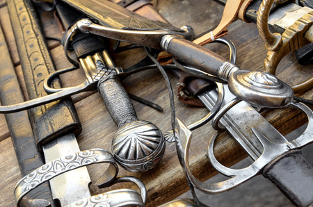 medieval swords on a wood tableの写真素材