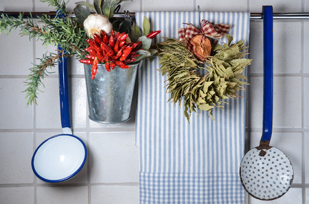 Vintage kitchen wall with rag, blue spoons and spicesの写真素材