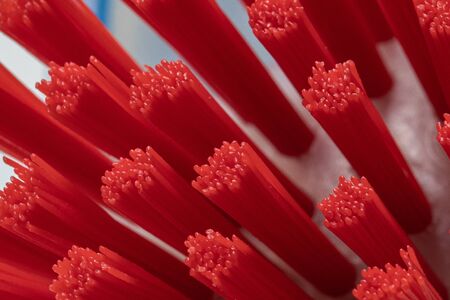 macro photography of a brush with red plastic bristlesの写真素材
