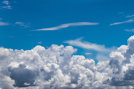 blue sky with scattered white fluffy cloudsの写真素材