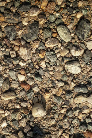 background made with stones of various sizes and colors scattered on the ground