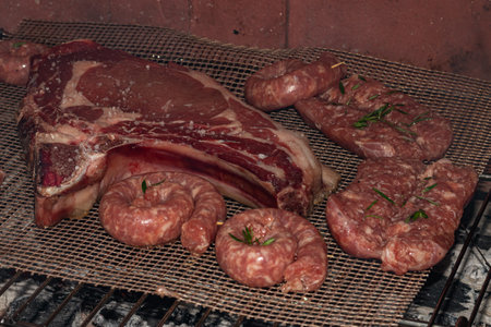 A Sizzling Feast of Mixed Meats and Sausages on the BBQ Grill - Perfect for Your Next Cookoutの写真素材