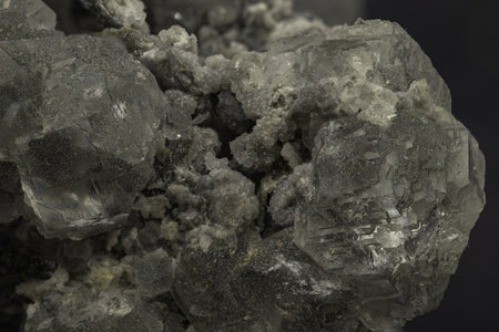 Macro shot of translucent celestine crystals displaying cubic structure on dark background