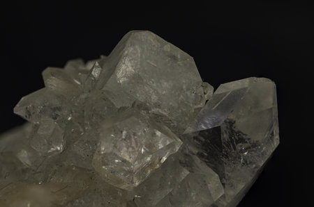 Elegant natural crystal cluster with multiple transparent points, beautifully lit against a dark backdrop, perfect for scientific study, collection, or as a decorative mineral specimenの写真素材