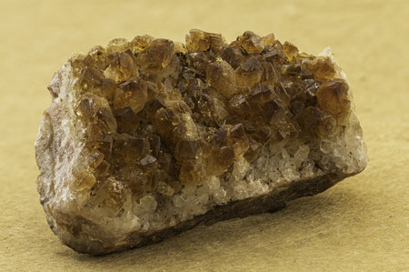 Macro shot of stunning golden brown mineral crystals with defined points and natural clarity, suitable for scientific illustration, mineralogical collections, or as a decorative gemstone specimenの写真素材