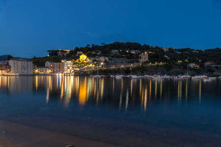 The bay of silence in Sestri Levante illuminated at twilighの写真素材