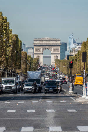 Paris, France - 09/15/2018: The road of the Champs Elysées with the Arch of Triumph in the...