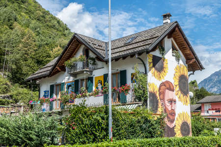 Baceno, Italy - 08/22/2020: house with sunflowers an Frida painted on the facadeのeditorial素材